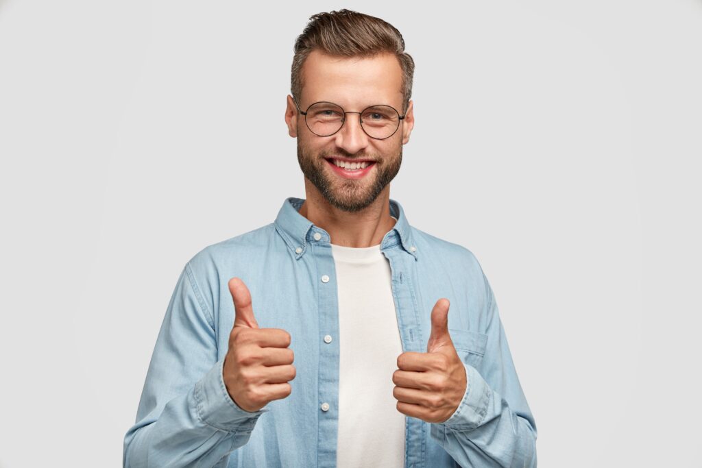 handsome bearded guy posing against white wall