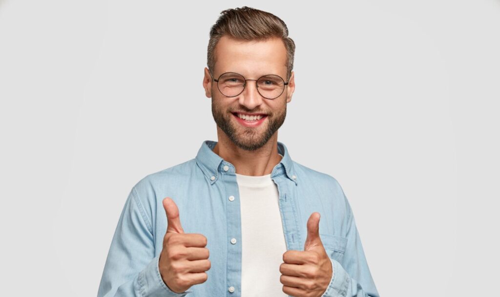 handsome bearded guy posing against white wall